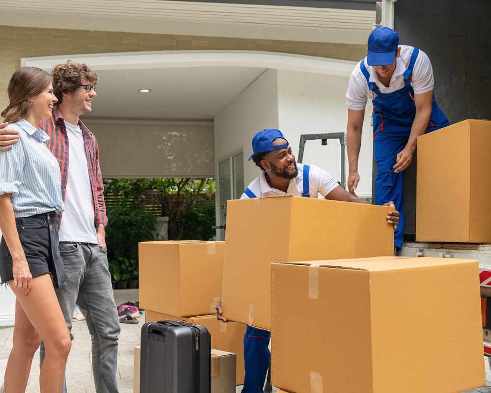 Moving-Company-Professionals-Packing-the-Truck-with-the-Moving-Couple-Looking-On